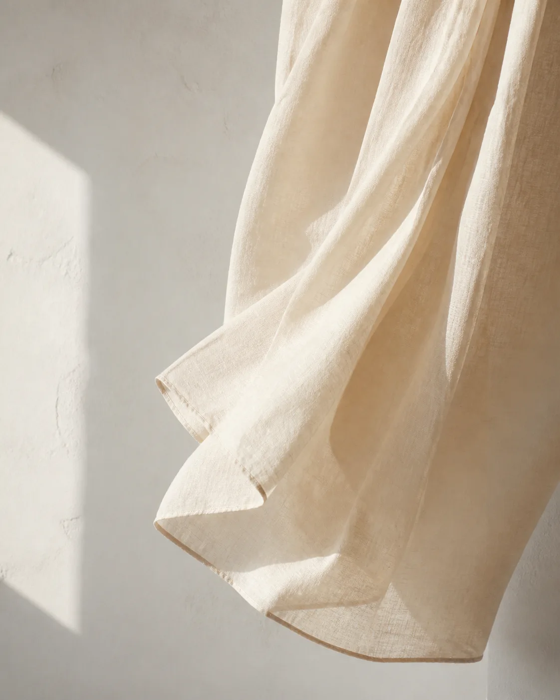 Cream linen moving in soft morning light