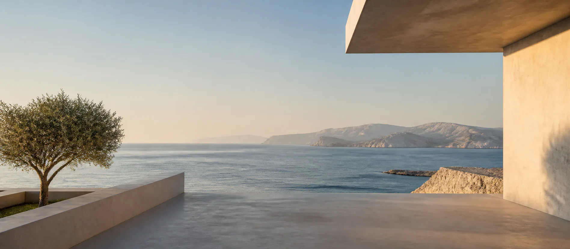 Concrete terrace opening toward a calm sea